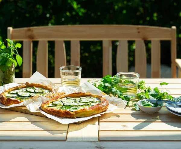 Сыр и капусту подают на открытом воздухе на садовом столе с белым вином. Концепция питания на открытом воздухе — стоковое фото