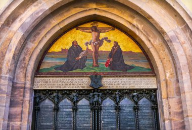 95 Theses Door Luther Jesus Crucifixion Mosaic Castle Church Schlosskirche Lutherstadt Wittenberg Germany.  Door where Luther posted 95 thesis 1517 starting Protestant Reformation.  Mosaic and door built 1858 clipart