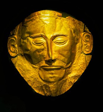 Athens, Greece - March 9, 2018 Golden Funeral Mask of Agamemnon Trojan War Statue National Archaeological Museum Athens Greece. Mask 1550 1500 BC from Mycenae Greece. . clipart