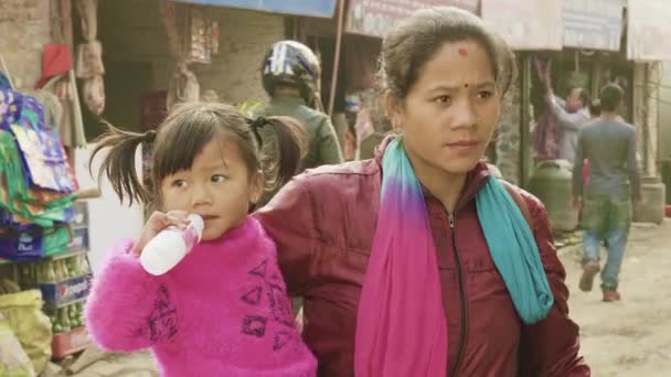 KATHMANDU, NEPAL - MARCH, 2018: Young mother holds her child on hands, march, 2018. — Stock Video