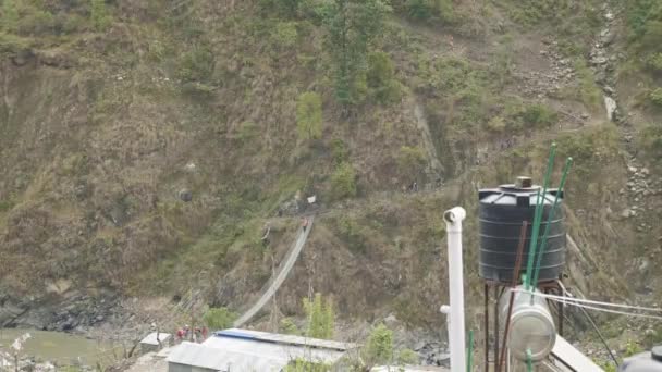 Backpacker wandern auf der Hängebrücke auf dem Manaslu Circuit Trek. — Stockvideo