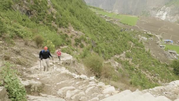 Pareja caminando por las escaleras en la caminata alrededor de Manaslu, aldea Prok, Nepal . — Vídeos de Stock