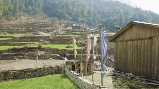 Farbige Flaggen im nepalesischen Dorf lho. Manaslu Circuit Trek. — Stockvideo
