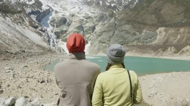 Couple seat at the mountain lake Birendra in Nepal. Manaslu area. — Stock Video