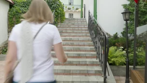 Young woman running on stairs. — Stock Video