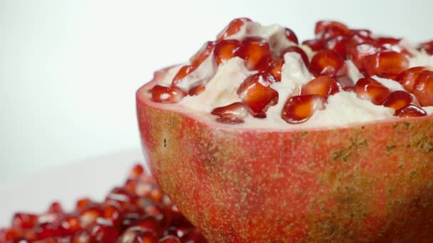 Pomegranate and grains on a rotating table — Stock Video