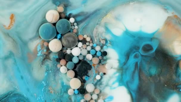 Colorful paint in bubbles organically moves in the liquid — Stock Video