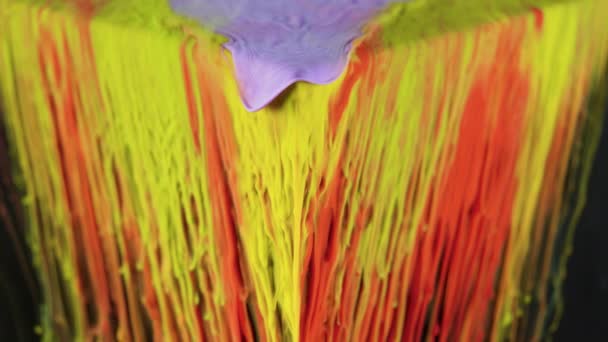 Multicolored ink paint slowly flows from the cube underwater — Stock Video