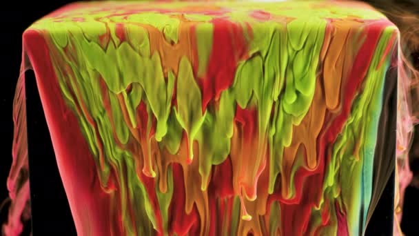 Multicolored ink paint slowly flows from the cube underwater — Stock Video