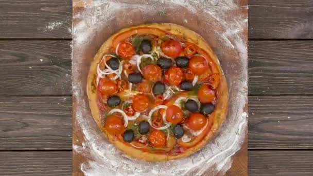 Top view of vegetarian pizza eating on wooden plate, stop motion animation — Stock Video