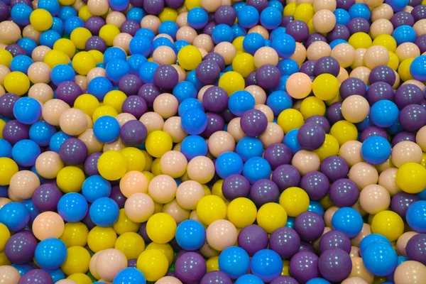 Colorful child balls. Multi-colored plastic balls. Achildren\'s playroom. Background texture of multi-colored plastic balls on  playground