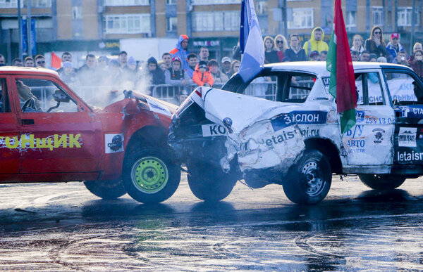 KAZAN, RUSSIA - APRIL 29, 2018: Extreme auto show - car revolt. Cars and drivers in  small arena compete in derby with  demolition. Fighting cars for survival after severe collisions and acciden