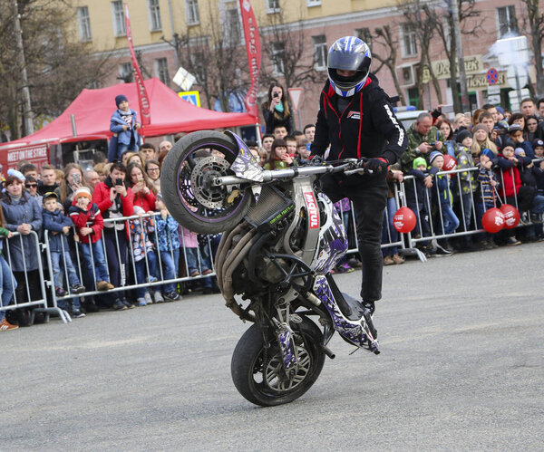 YOSHKAR-OLA, RUSSIA - MAY 5, 2018: Motoshow in central square of  city. Tricks on motorcycle, stuntmen, Stunt Riding - Wheelie, Stoppie and Akrobatyka on motorcycle.