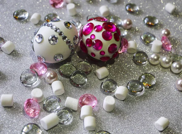 Easter composition flatlay. Easter eggs decorated with shiny rhinestones on  silver background with glass ornaments and pearl beads. — Stock Photo, Image