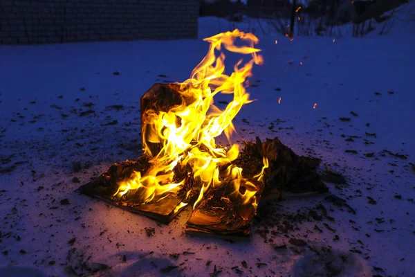 burning book in  snow. pages with the text in  open book burn wi