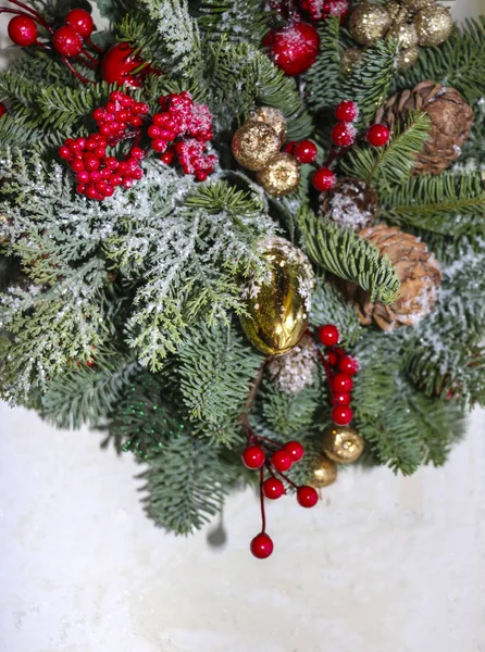 Christmas composition of pine branches, golden Christmas decorations, red berries and artificial snow. — Stock Photo, Image