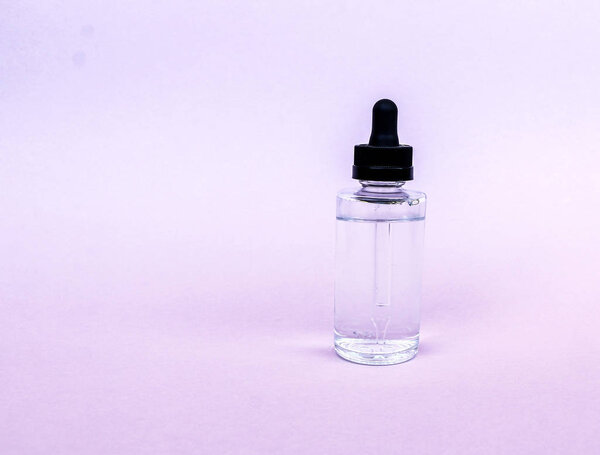  glass bottle with pipette with oil, serum  on  empty background. Concept: Organic bio cosmetics, herbal oils, serum collagen, skin care