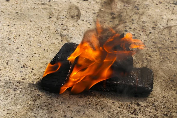 Burnt mobile phones on textural concrete background. Concept: Danger of using low-quality cell phones. — Stock Photo, Image