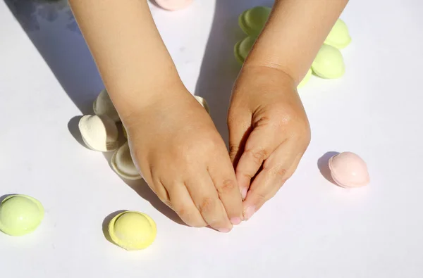 Children's hands are making multicolored small pelmeni for festive feast. — Stock Photo, Image