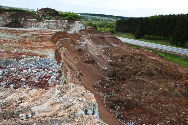 textures of various clay layers underground in  clay quarry after  geological study of the soil. colored layers of clay and stone in  section of the earth, different rock formations and soil layers.