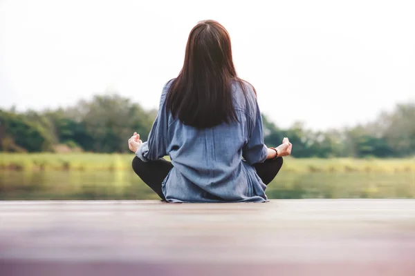 stock image Young Woman Practices Yoga in Outdoor. Sitting in Lotus Position