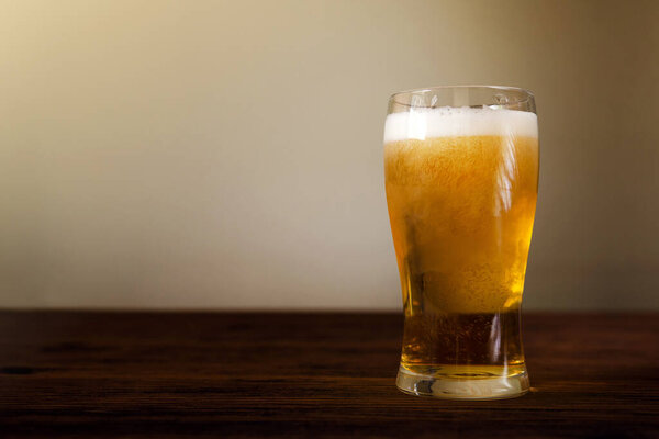 Glass of Beer on Wooden Table. Front View. Shot with Natural Day