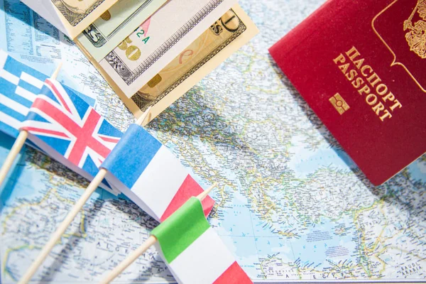 Going to travel. Passport, money, flags of Greece, UK, Italy, France on map. Save money on travel, planning for budget concept.