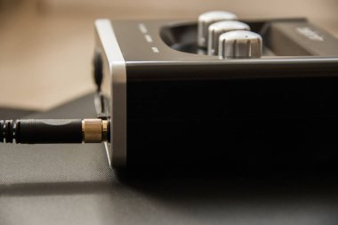 Headphone cable in the headphone jack. external sound card,mixer in home studio of musician