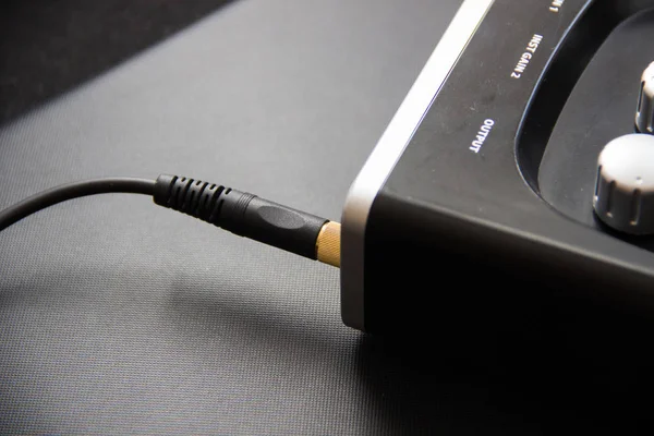 Headphone cable in the headphone jack. external sound card,mixer in home studio of musician — Stok fotoğraf