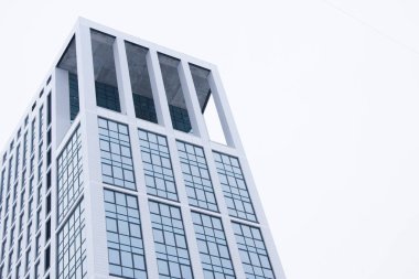 Mavi cam pencerelerin bulunduğu yüksek katlı Ofis Binası
