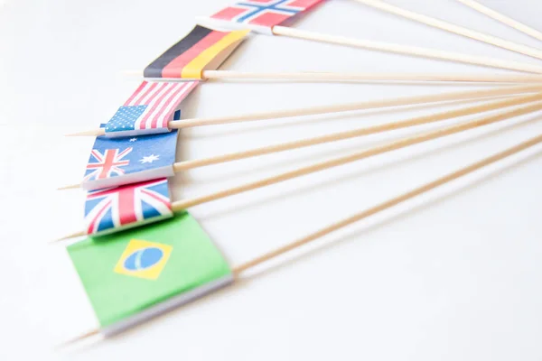 Bunch of miniature paper flags of several countries: Greece,Germany,Sweden,Norway,England,Italy,France,Spain, Russia