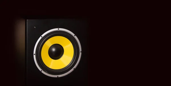 Yellow loudspeaker close on the dark background close up shot — Stock Photo, Image