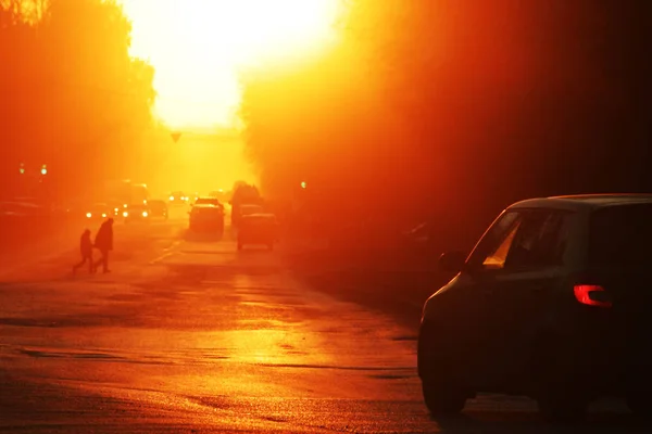 A beautiful sunset in a town, perspective view of the road. The machine turns