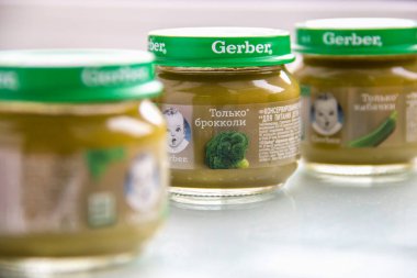 MOSCOW, RUSSIA - 12 Eylül 2020: Masanın üzerinde çocuk beslenme sebze mırrası olan Gerber cam kavanozları. Brokoli ve kabaklar beslenmek için. Fotoğrafı kapat.