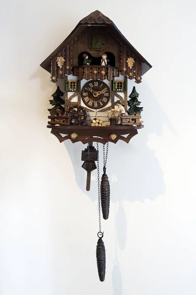 wooden cuckoo clock  traditional german white wall