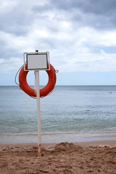 sign for text near the beach. drowning rescue circle