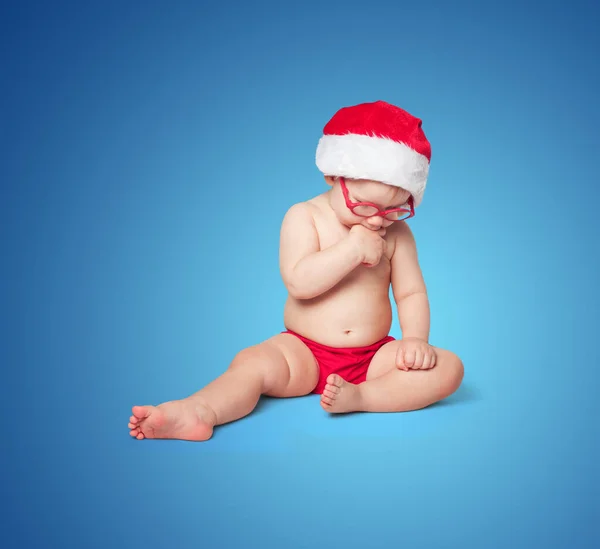 Little Cute Baby Red Santa Hat Red Glasses Sits Blue — Stock Photo, Image