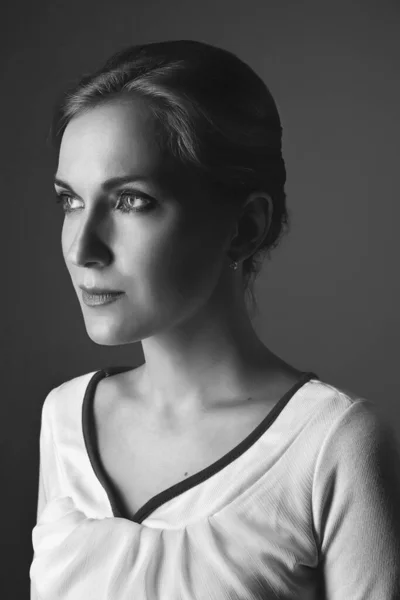 portrait of the beautiful, sure girl. on a dark background in studio