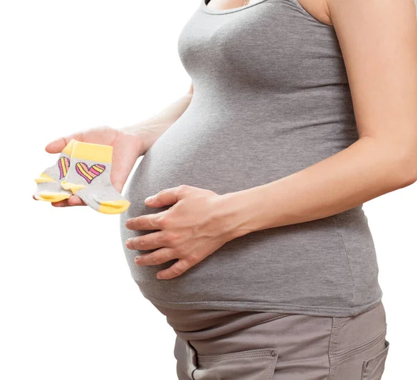Mujer Embarazada Tiene Los Calcetines Infantiles Mano —  Fotos de Stock