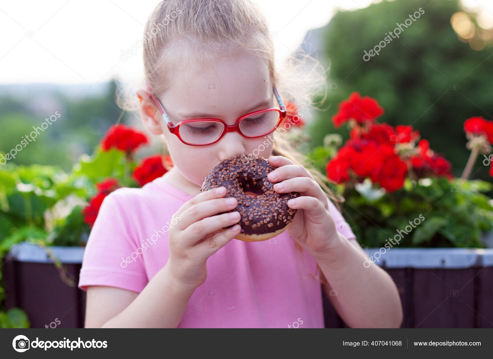 Little Girl Glasses Pink Dress Eating Sweet Donut Stock Photo by