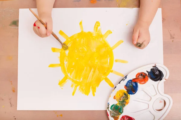 View Child Draws Brush Paints White Paper Sun — Stock Photo, Image