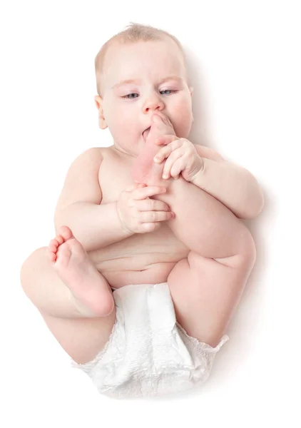 Small Beautiful Caucasian Child Lies Back Licks Foot Isolated White — Stock Photo, Image