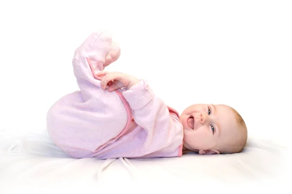 Little Girl Lies Fabric Hold Foot Hand Laughs Isolated White — Stock Photo, Image