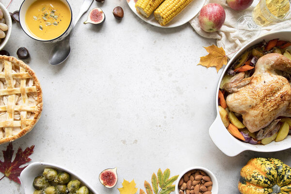 Thanksgiving dinner with chicken, apple pie, pumpkin soup brussel sprouts and fruits. Traditional autumn food concept. Flat lay. 