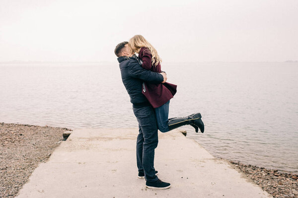 couple hugging on a pier