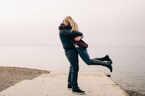 couple hugging on a pier