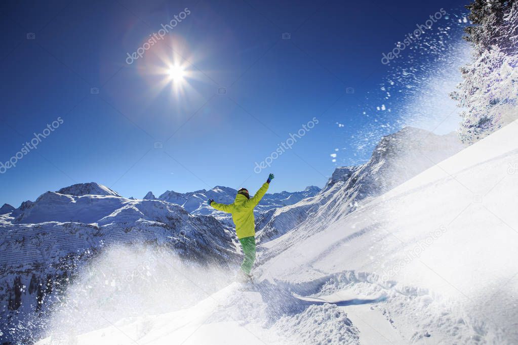 A snowboarder on the piste in Alps in Austria