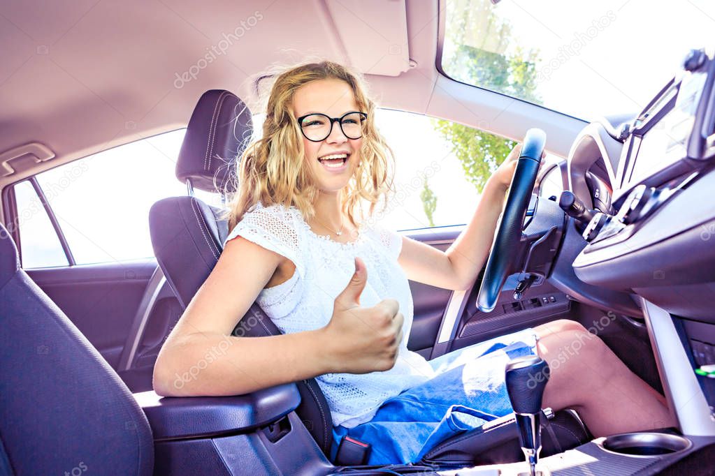 a young girl after successfully driving exam in a car