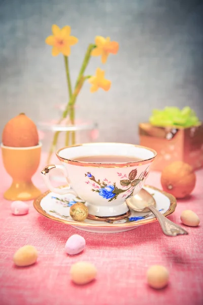 Paskalya yükleme ile bir fincan, narcissi ve tatlılar