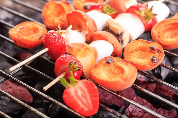 close up shut of marshmallows and fruits on the grill